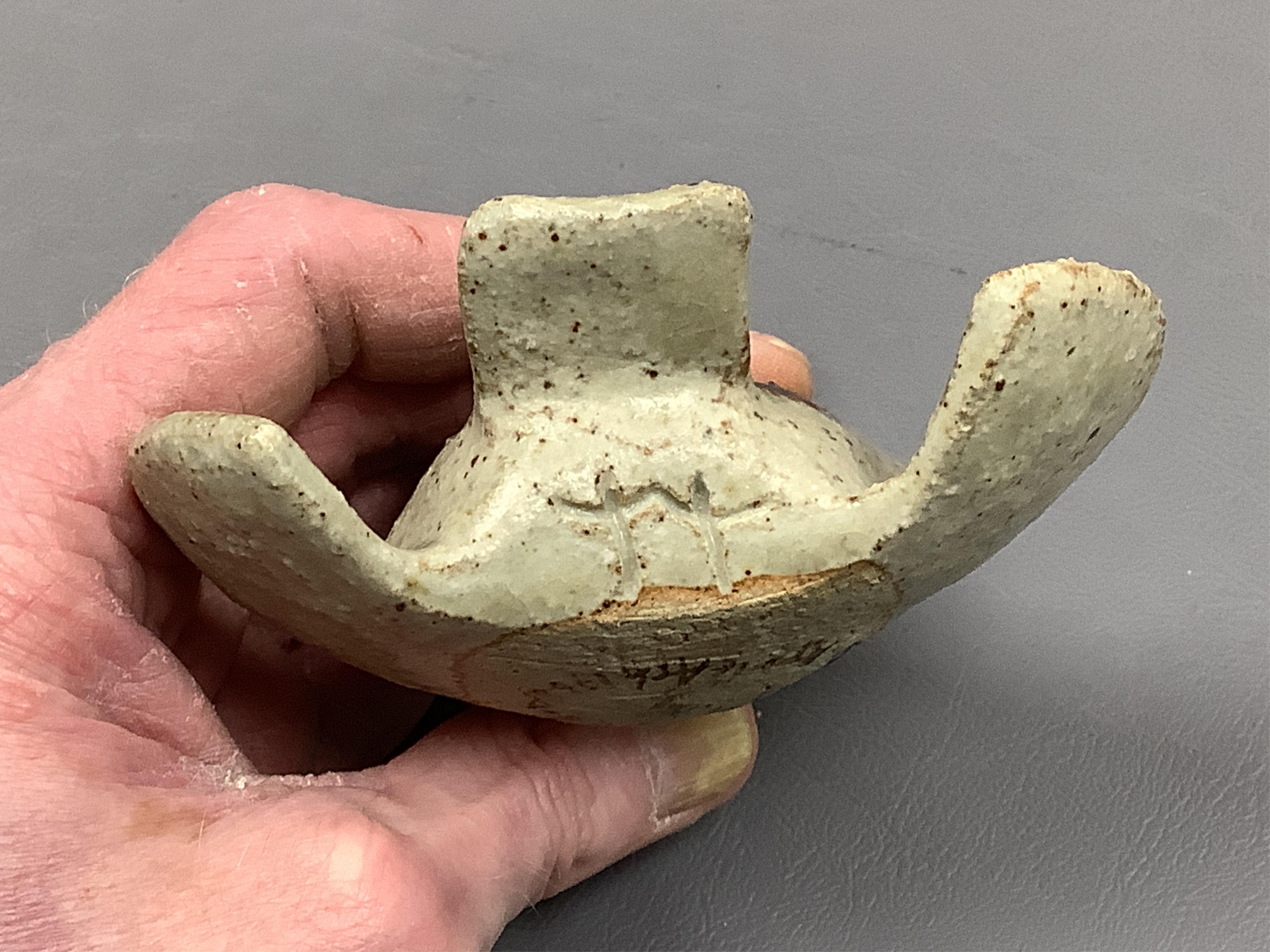 Eric James Mellon (1925 - 2014), a small studio pottery and apple ash-glazed model of a bird, 10cm wide